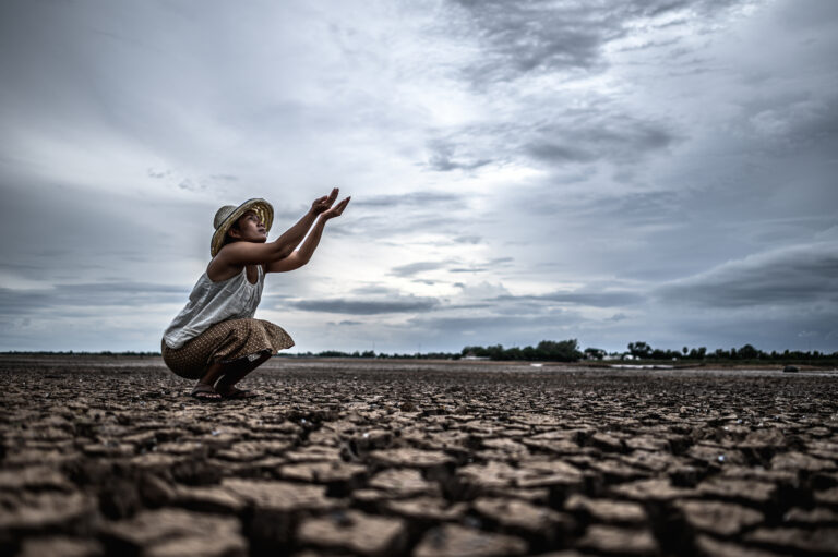 A woman is sitting asking for rain in the dry season,global warm