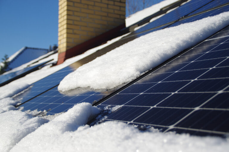 Solar PV panels covered by snow on the home roof during winter o