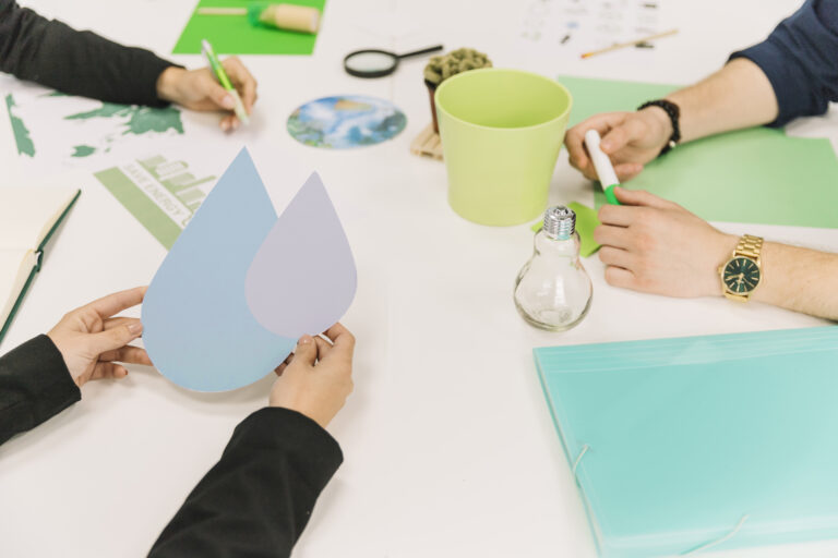 close-up-businessperson-s-hand-holding-water-drop-symbol (1)
